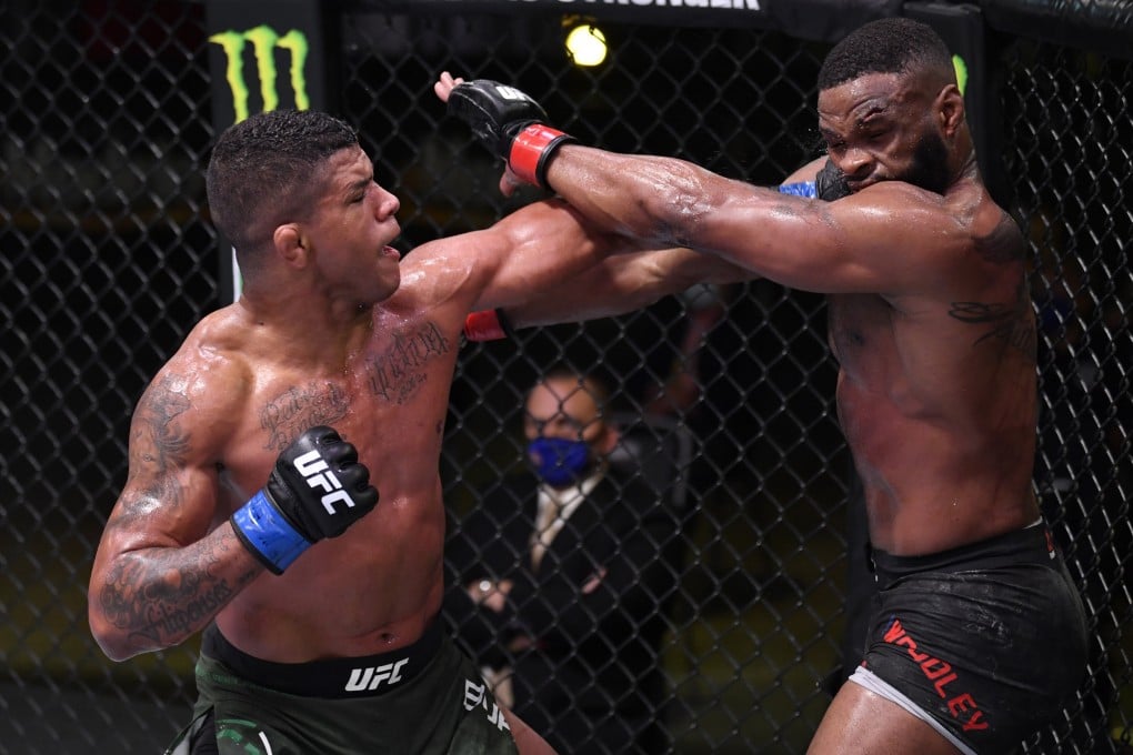 Gilbert Burns punches Tyron Woodley in their welterweight bout during UFC Fight Night. Photos: USA TODAY Sports