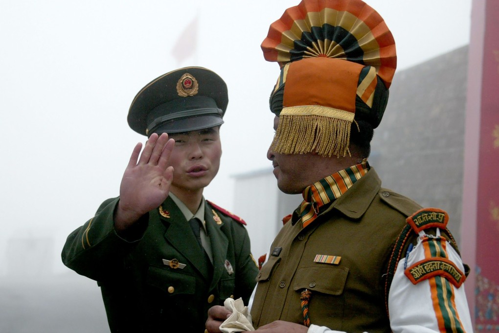 A Chinese soldier and an Indian soldier near the shared border in India’s northeastern Sikkim state. File photo: AFP
