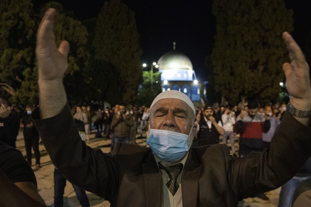 Palestinian Muslims attend Al-Fajr prayer for the first time in more than two months at Al Aqsa mosque, in Jerusalem’s old city, after it was reopened. Photo: EPA