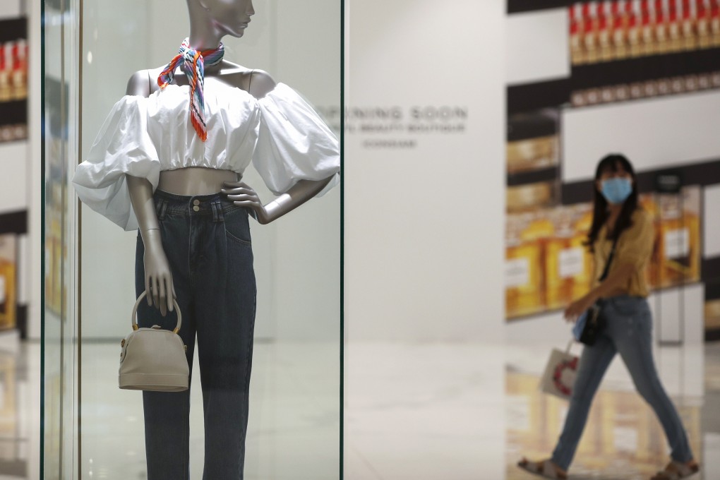 A Thai shopper wearing a face mask amid the coronavirus pandemic walks past a mannequin at a shopping centre in Bangkok. Photo: EPA