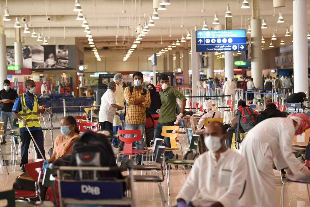 Indians at Dubai airport wait to fly home on May 7 on specially arranged flights amid pandemic travel bans. Many expatriate Indians have lost their jobs in the Gulf after oil prices collapsed. Photo: AFP