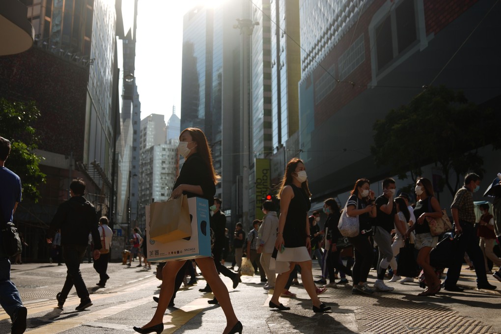 Pedestrians in protective face masks crossing the road in Causeway Bay, a busy shopping district in Hong Kong. Photo: Sam Tsang