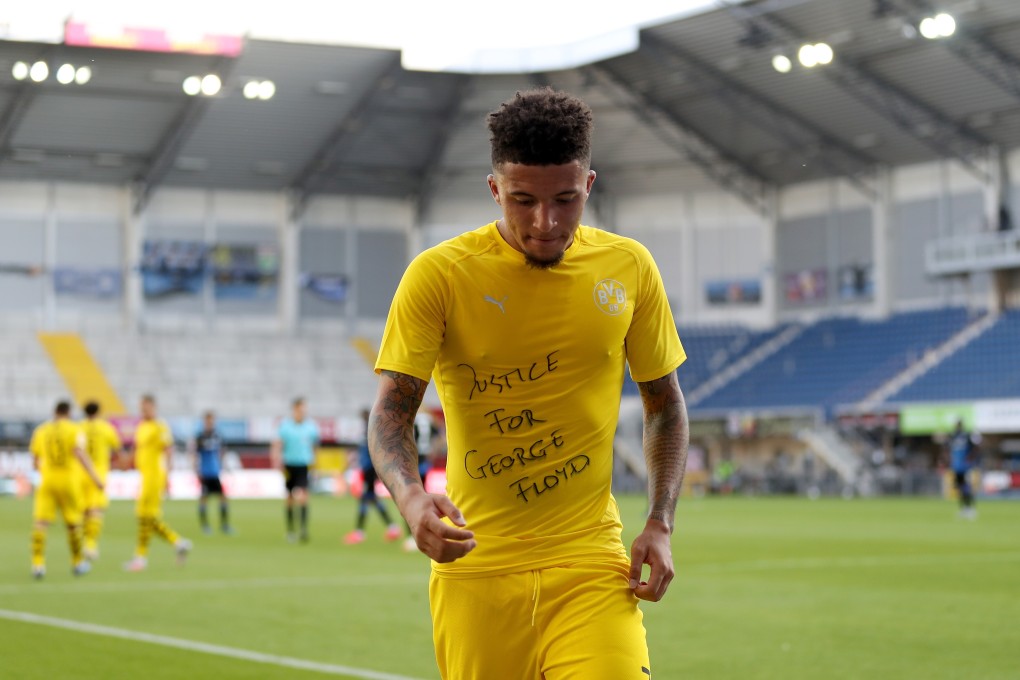 Jadon Sancho of Borussia Dortmund celebrates after scoring with a ‘Justice for George Floyd’ shirt. Photo: EPA