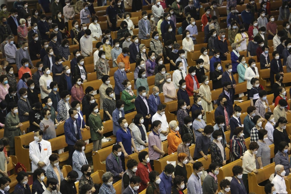 Christians wearing face masks to help protect against the spread of coronavirus pray during a service at the Yoido Full Gospel Church in Seoul on Sunday. Photo: AP