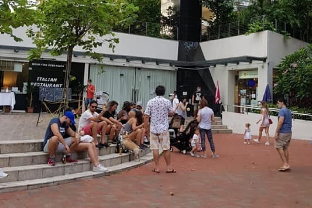 People are seen gathering and drinking outside a restaurant in Robertson Quay in Singapore in May, during the circuit breaker restrictions. Seven foreigners have been charged with flouting social distancing rules. Photo: Facebook