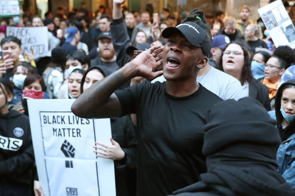 UFC middleweight champion Israel Adesanya joins some 4,000 New Zealand protesters demonstrating against the killing of Minneapolis man George Floyd in a Black Lives Matter protest in Auckland in June. Photo: AFP