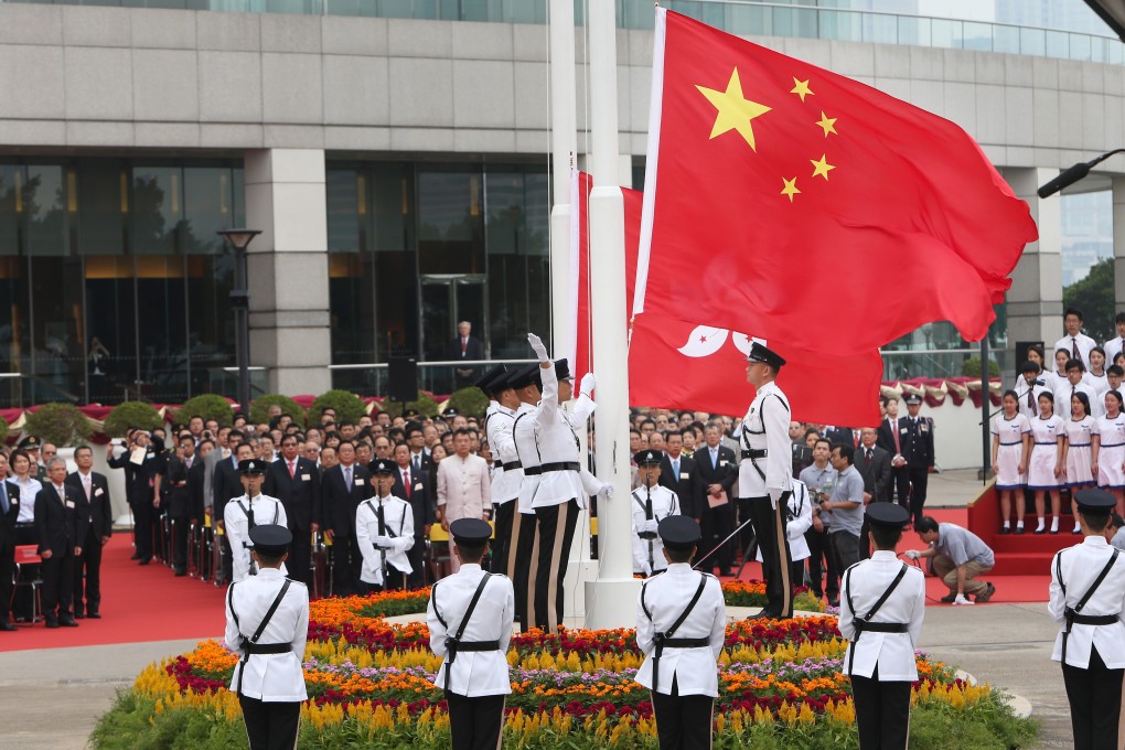 People attend a flag-raising ceremony at Golden Bauhinia Square in Hong Kong on October 1, 2012. Twenty-three years after the handover of sovereignty from Britain to China, Hong Kong’s legislature has not enacted a national security law as required under Article 23 of the Basic Law. Photo: Sam Tsang