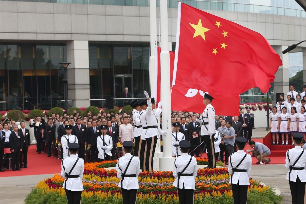 People attend a flag-raising ceremony at Golden Bauhinia Square in Hong Kong on October 1, 2012. Twenty-three years after the handover of sovereignty from Britain to China, Hong Kong’s legislature has not enacted a national security law as required under Article 23 of the Basic Law. Photo: Sam Tsang