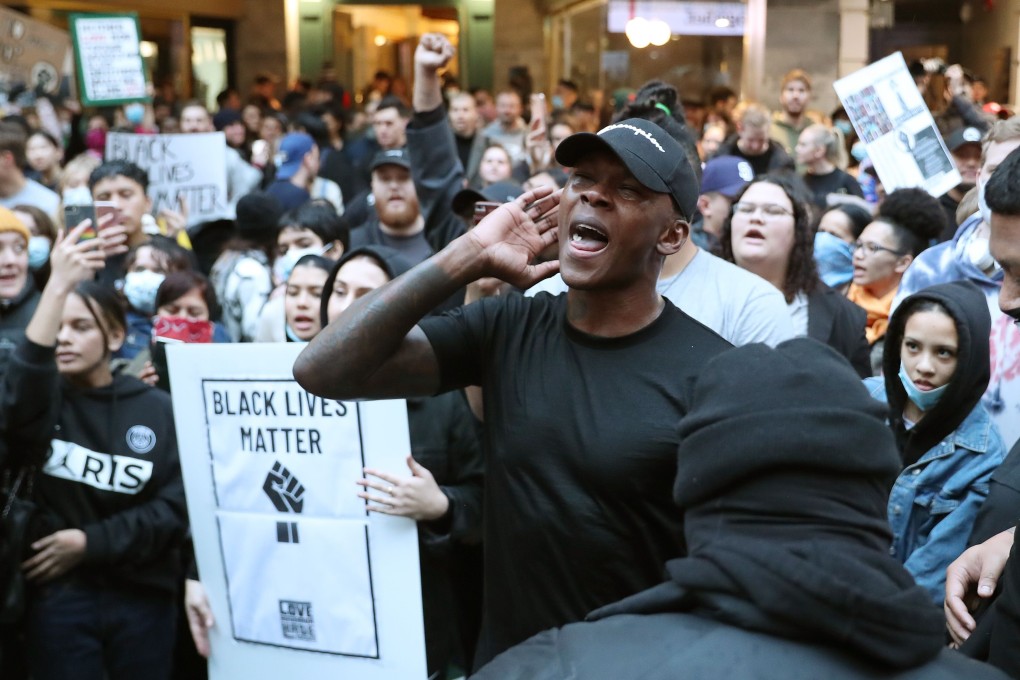 UFC middleweight champion Israel Adesanya joins roughly 4,000 New Zealand protesters demonstrating against the killing of Minneapolis man George Floyd in a Black Lives Matter protest in Auckland in June. (Photo: AFP