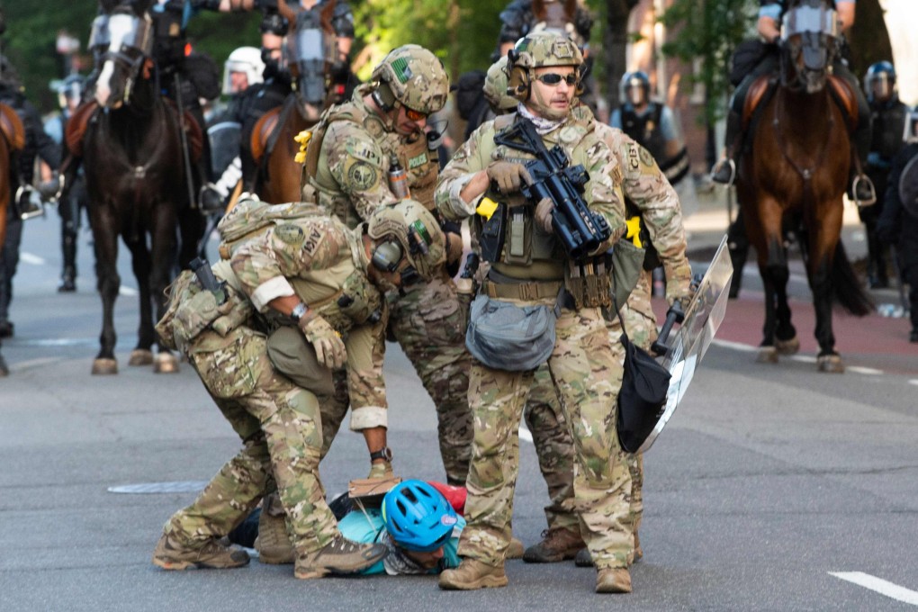 Military police officers restrain a protester near the White House as demonstrations against George Floyd's death continue. Photo: AFP