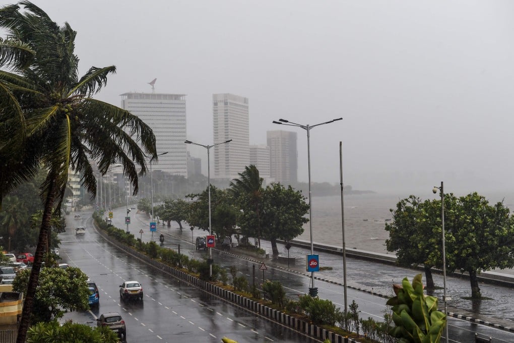 Motorists drive on a road near the Marine Drive under heavy rain in Mumbai. Photo: AFP