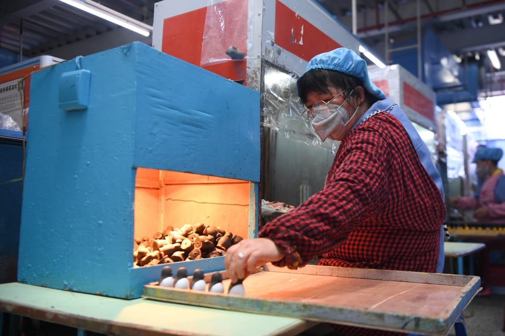 A worker makes toys at a plastic product factory in Zhangjiajie, central China's Hunan Province. Photo: Xinhua