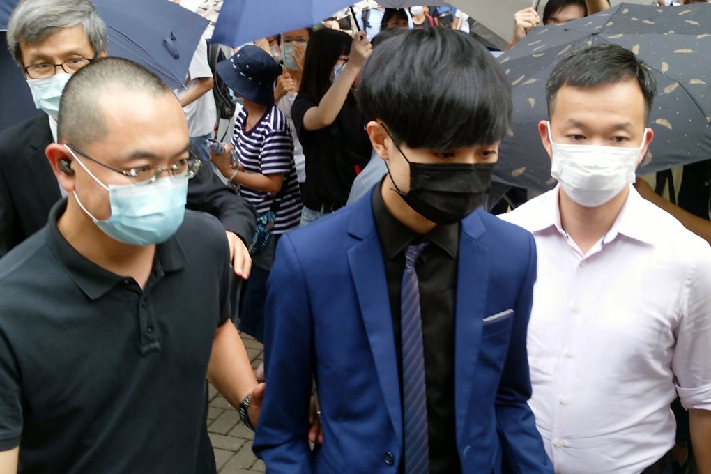 Chow Pak-kwan (centre) walks out of West Kowloon Court after being granted bail on Tuesday. Photo: Brian Wong