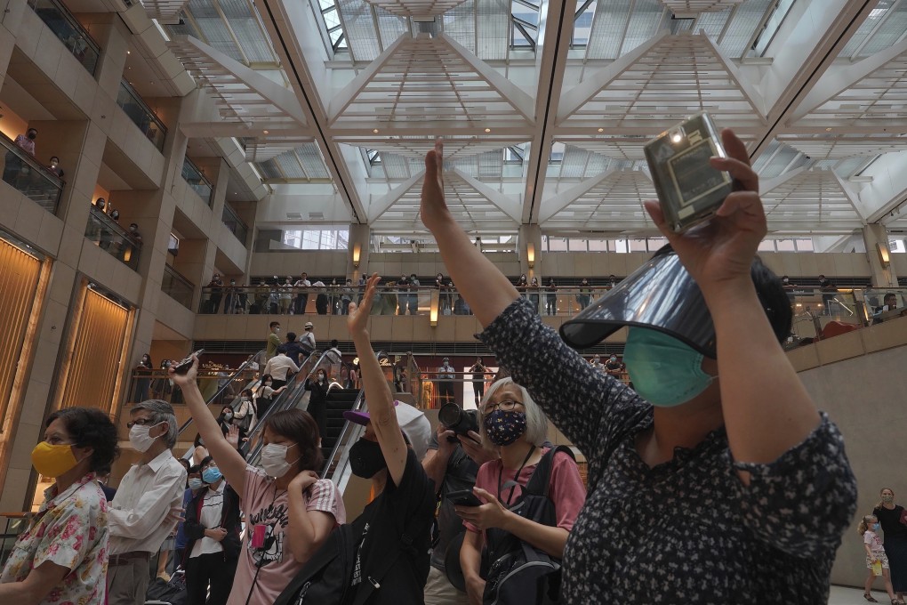 Protesters gesture with five fingers, signifying “five demands, not one less”, in a shopping centre during a protest on June 1 against China's national security legislation for Hong Kong. Photo: AP