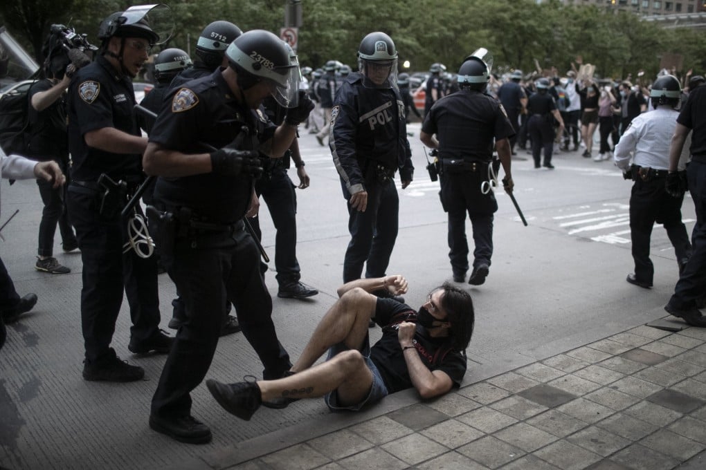 Police arrest protesters who did not get off the streets during a curfew in New York on Tuesday. Photo: AP