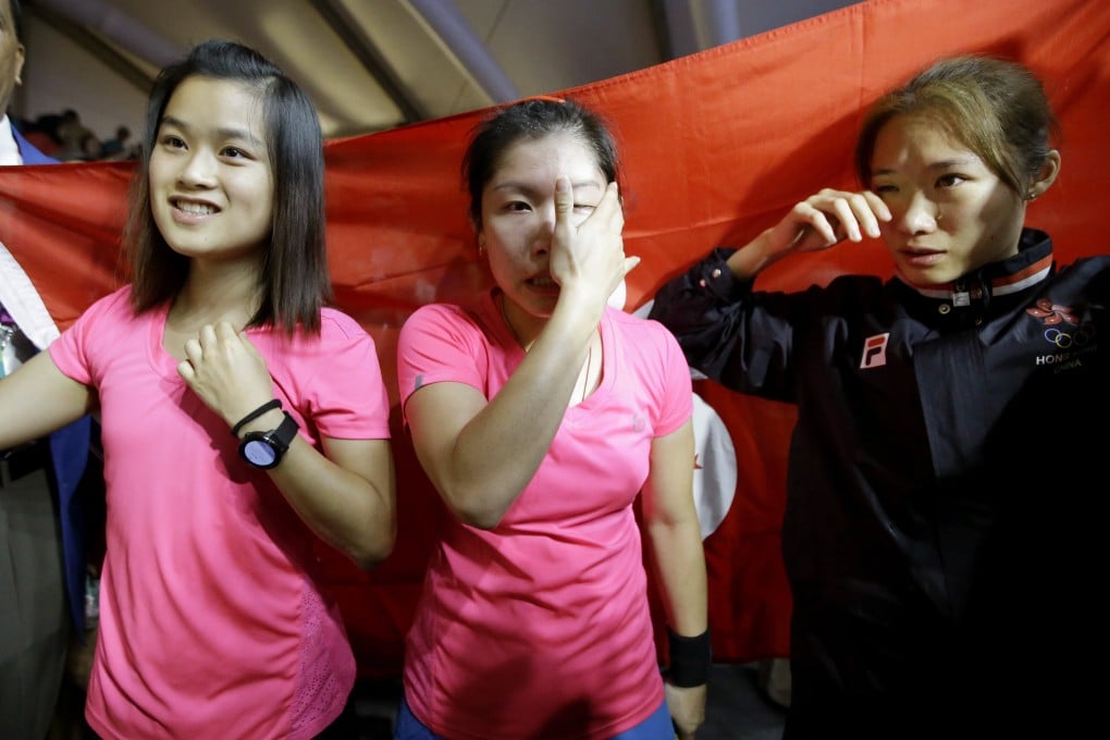 Annie Au (middle) and Joey Chan (right) shed tears of joy after winning the women’s team gold medal at the 2018 Asian Games. Au and Chan have now retired from the sport with Ho Tze-lok now leading the team. Photo: AP