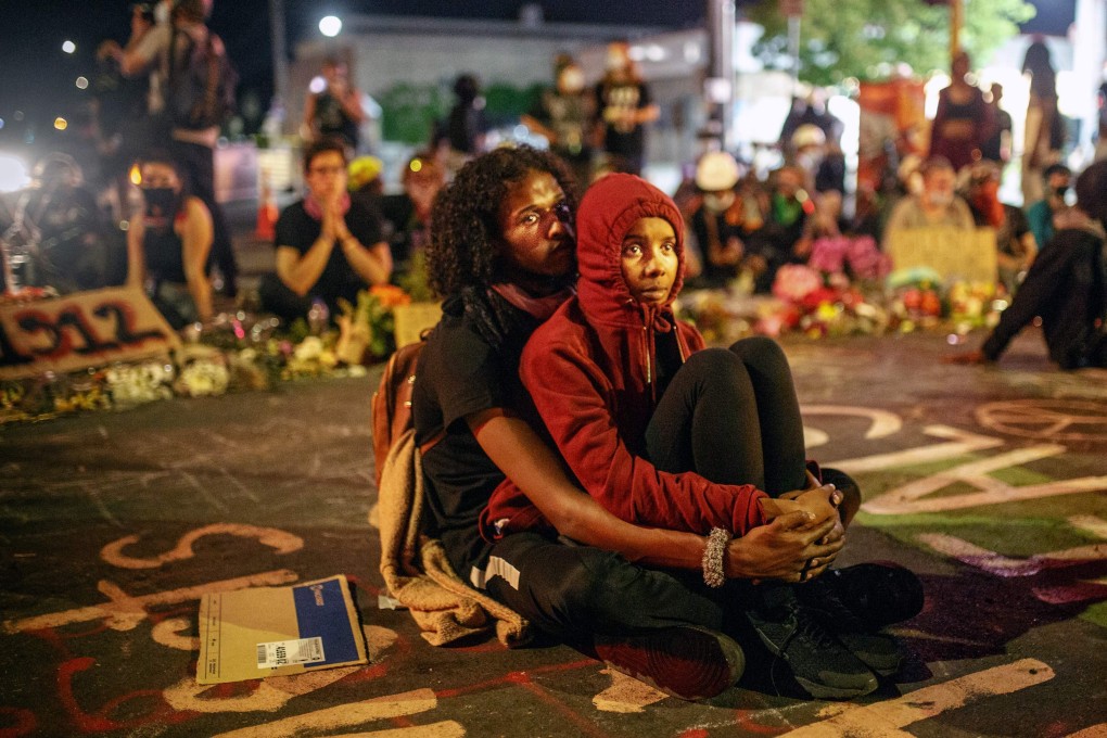 A Somali-American couple join protesters calling for justice after the death of George Floyd in Minneapolis, Minnesota. Photo: AFP
