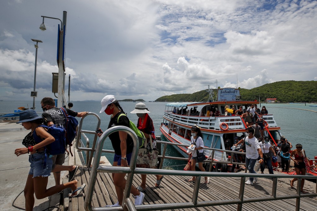 Tourists disembark a ferry at Koh Larn island on the first day of reopening in Pattaya in Thailand. Photo: EPA