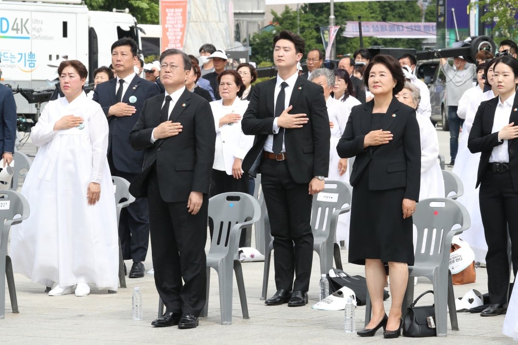 South Korean President Moon Jae-in, second left, and his wife Kim Jung-sook, second right, salute the national flag during an annual ceremony to mark the 40th anniversary of the Gwangju Uprising last month. Photo: DPA