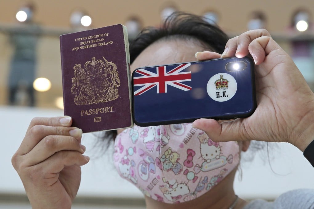 A protester in Hong Kong holds a British National (Overseas) passport during a protest against China’s national security legislation for the city. Photo: AP