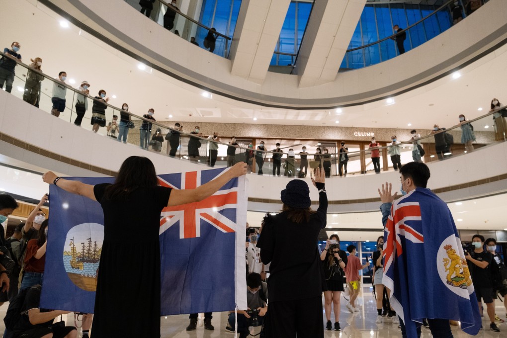 Demonstrators hold colonial-era Hong Kong flags during a protest against China’s planned national security law for the city, at the IFC shopping mall in Central on May 25. In Hong Kong, a culture of superiority rests on a problematic belief that the city and its citizens are inherently superior by virtue of being a former colony. Photo: Bloomberg