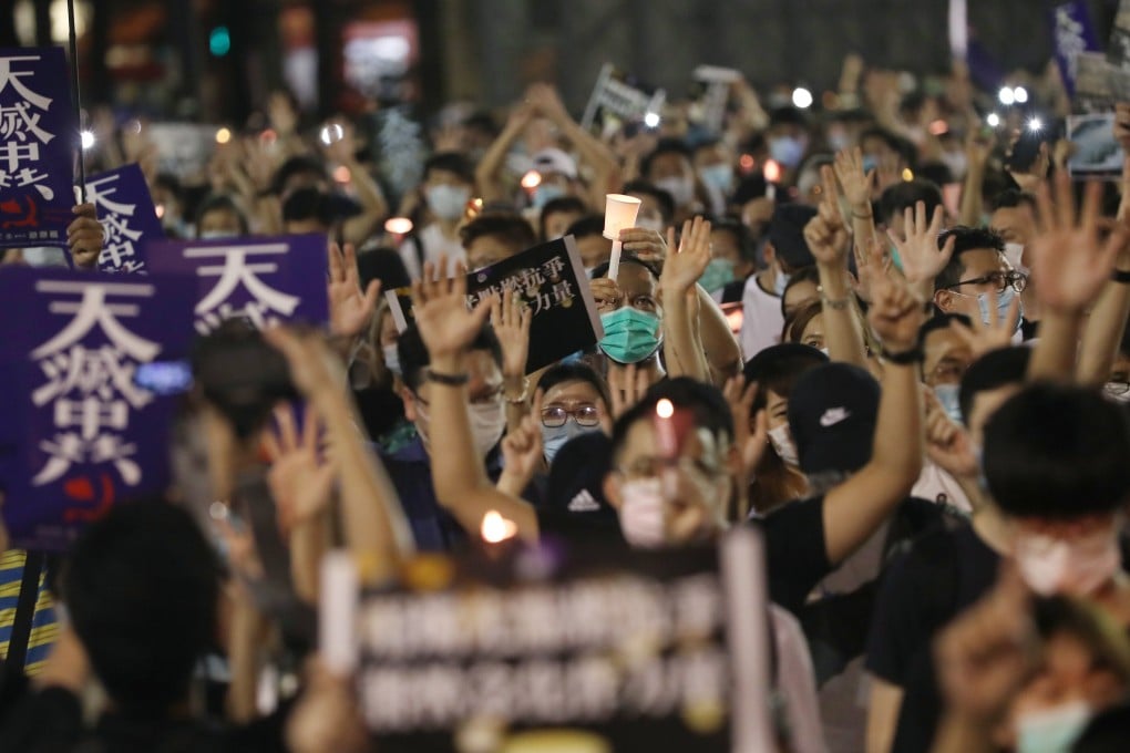 At Victoria Park, social-distancing rules were set aside as participants lit candles in remembrance of the victims of the June 4 crackdown. Photo: Sam Tsang