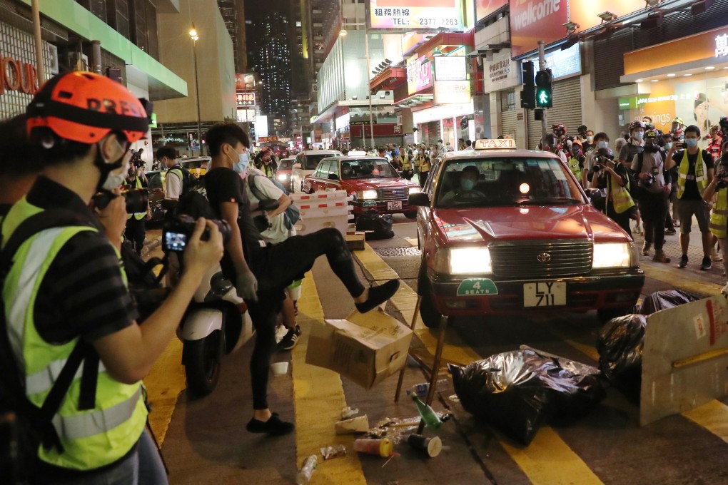 A member of the press records the scene as an anti-government protester attempts to disrupt traffic by blocking a road in Mong Kok on May 27, during a demonstration against the national anthem law and the national security law. Photo: Sam Tsang