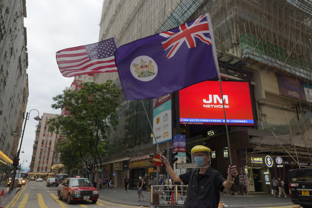A protester waves the US national flag and a Hong Kong colonial flag during a demonstration against China’s national security legislation for Hong Kong, in Causeway Bay on May 24. Photo: AP