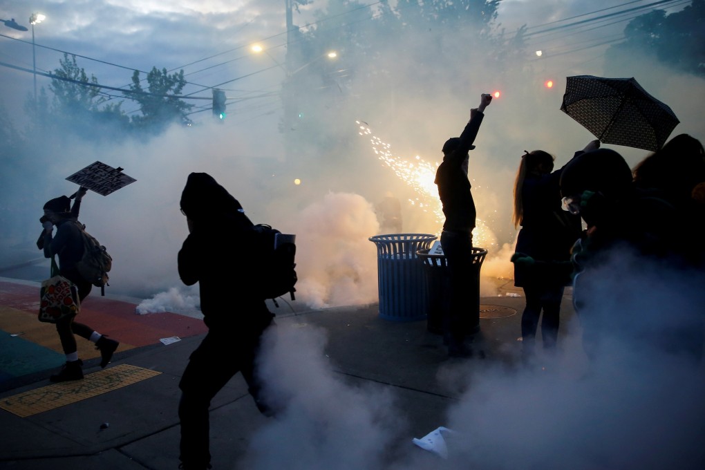 Protesters disperse as tear gas, pepper spray and flash bang devices are deployed by Seattle police during a demonstration over the death of George Floyd. Photo: Reuters