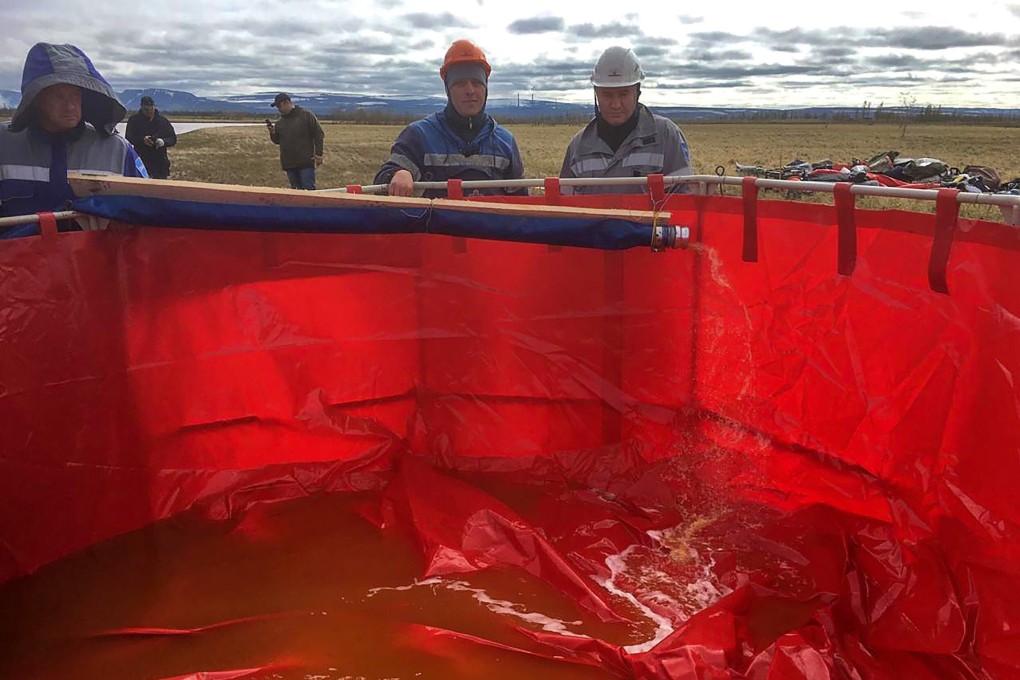 Workers pump out oil pollution from the Ambarnaya River outside Norilsk on June 5, 2020. Photo: AFP
