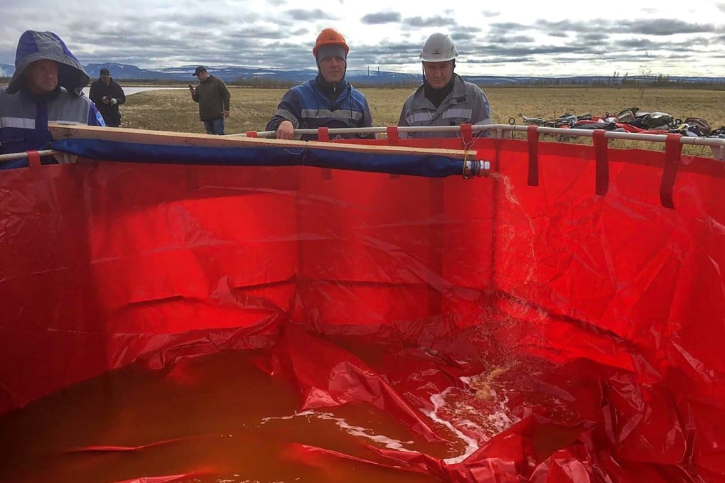 Workers pump out oil pollution from the Ambarnaya River outside Norilsk on June 5, 2020. Photo: AFP