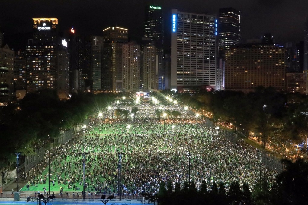 People take part in the annual Tiananmen candlelight vigil at Victoria Park in Causeway Bay, despite the event not being officially sanctioned due to the coronavirus outbreak. Photo: May Tse