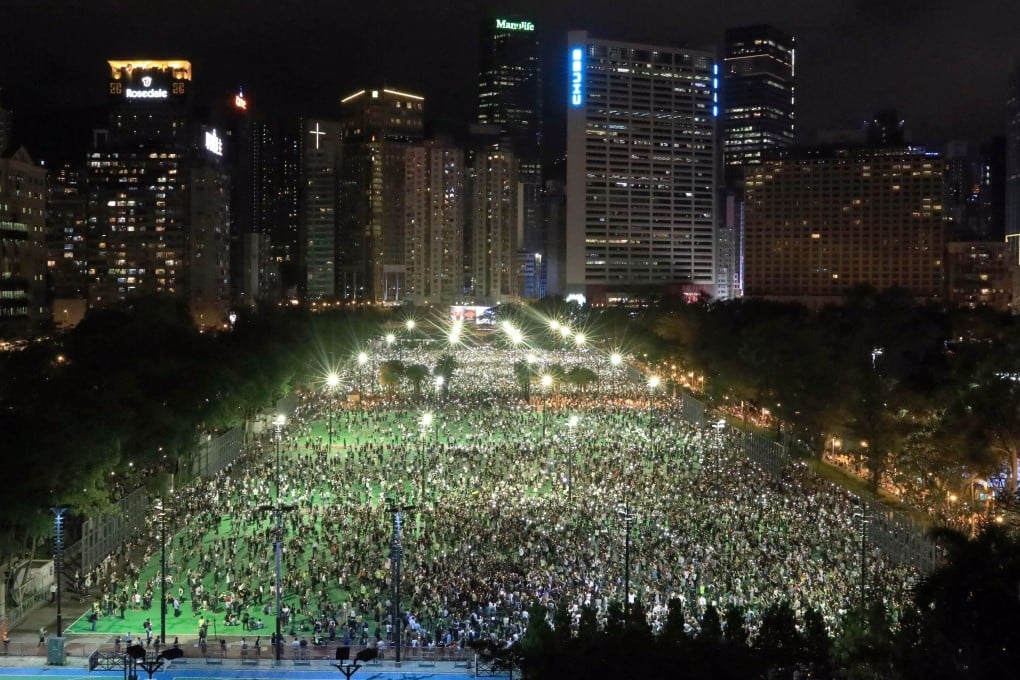 People take part in the annual Tiananmen candlelight vigil at Victoria Park in Causeway Bay, despite the event not being officially sanctioned due to the coronavirus outbreak. Photo: May Tse