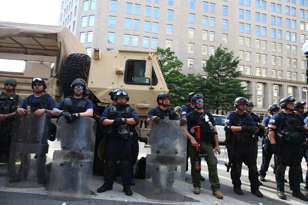 Law enforcement officers monitor protesters in Washington DC. Photo: Getty Images