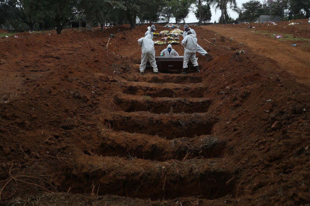 Gravediggers wearing protective suits bury person who died from Covid-19, at Sao Luiz cemetery, in Sao Paulo, Brazil. Photo: Reuters