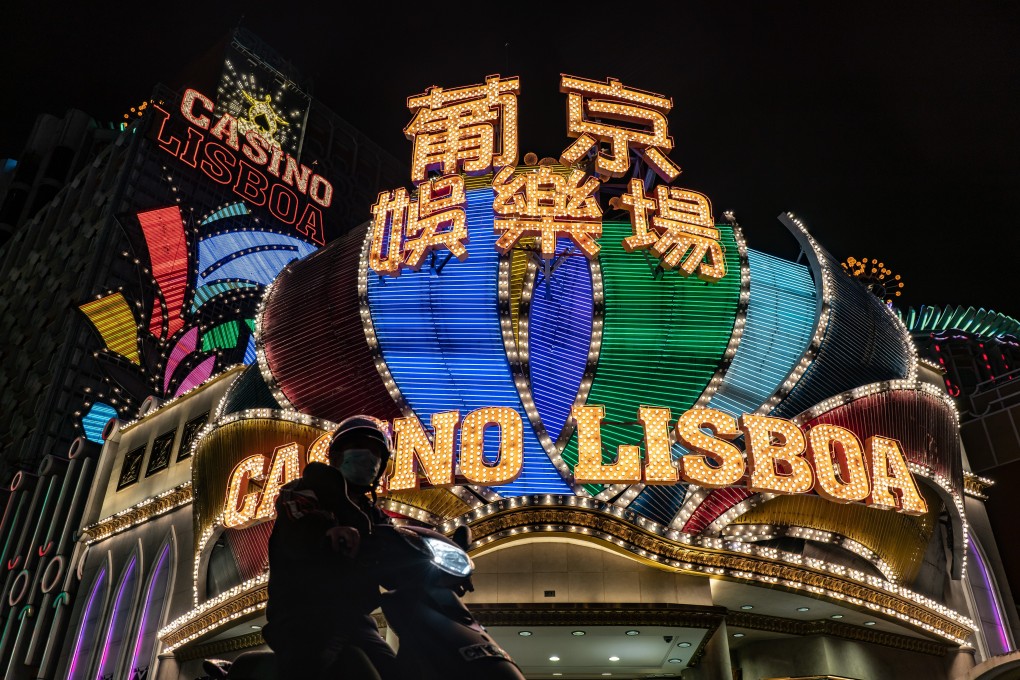 A motorcyclist stops for a traffic light in front of the Casino Lisboa in February in Macau, China. Casino malls are getting busier as residents return with shopping vouchers. Photo: Getty Images