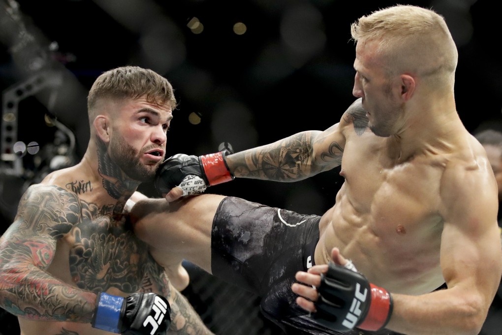 TJ Dillashaw kicks Cody Garbrandt at their UFC title bantamweight title fight at UFC 227 in Los Angeles in 2018. Photo: AP