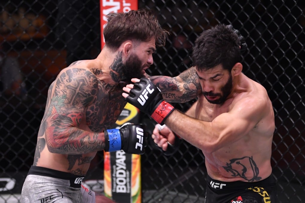 Cody Garbrandt punches Raphael Assuncao in their bantamweight bout during UFC 250. Photos: USA TODAY Sports