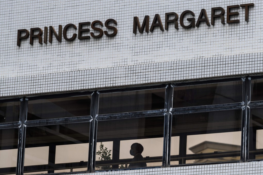 A medical worker walks on a bridge joining two buildings in the grounds of Princess Margaret Hospital in Hong Kong. It is among several public hospitals undergoing redevelopment to support future health care demands in the city. Photo: AFP