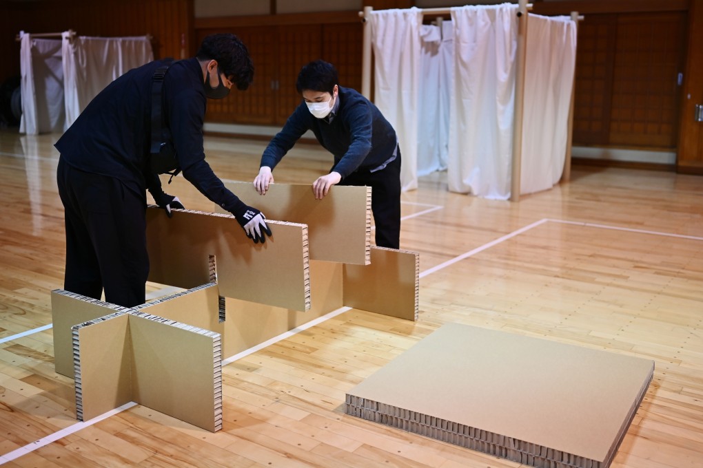 Workers from the Voluntary Architects’ Network build partitions and beds at a shelter in a judo sport hall in Yokohama, Kanagawa prefecture, Japan. They were devised by Japanese architect Shigeru Ban for people who cannot afford to rent an apartment and often stay at internet cafes that are now closed due to the coronavirus outbreak. Photo: AFP