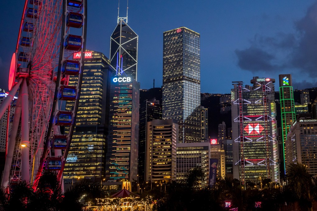 The HSBC headquarters stand illuminated among other buildings at dusk in Hong Kong. Photo: Bloomberg