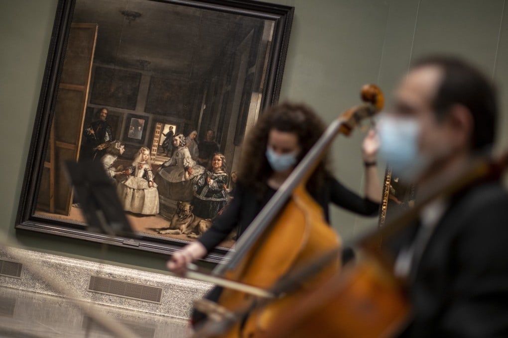 Musicians perform next to Las Meninas by Spanish artist Diego Velazquez at the reopening of the Prado museum to the public. With visitor numbers limited, there is more chance to admire the art on show. Photo: AP