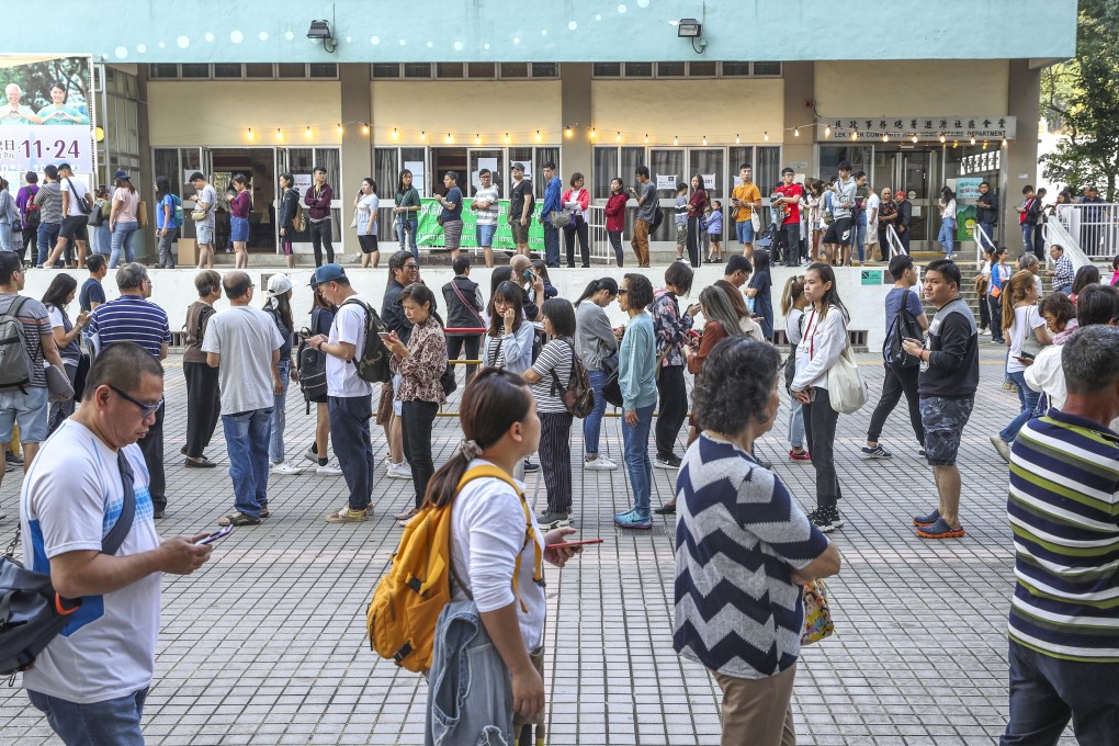 People queue up outside a polling station to cast their ballots at the district council elections in Hong Kong in 2019. Photo: Winson Wong