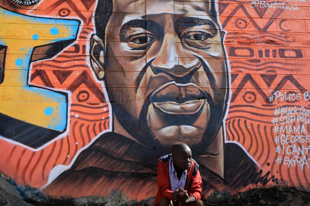 A man sits in front of graffiti in memory of George Floyd painted by Kenyan artists in support of the Black Lives Matter movement in Nairobi. Photo: EPA-EFE