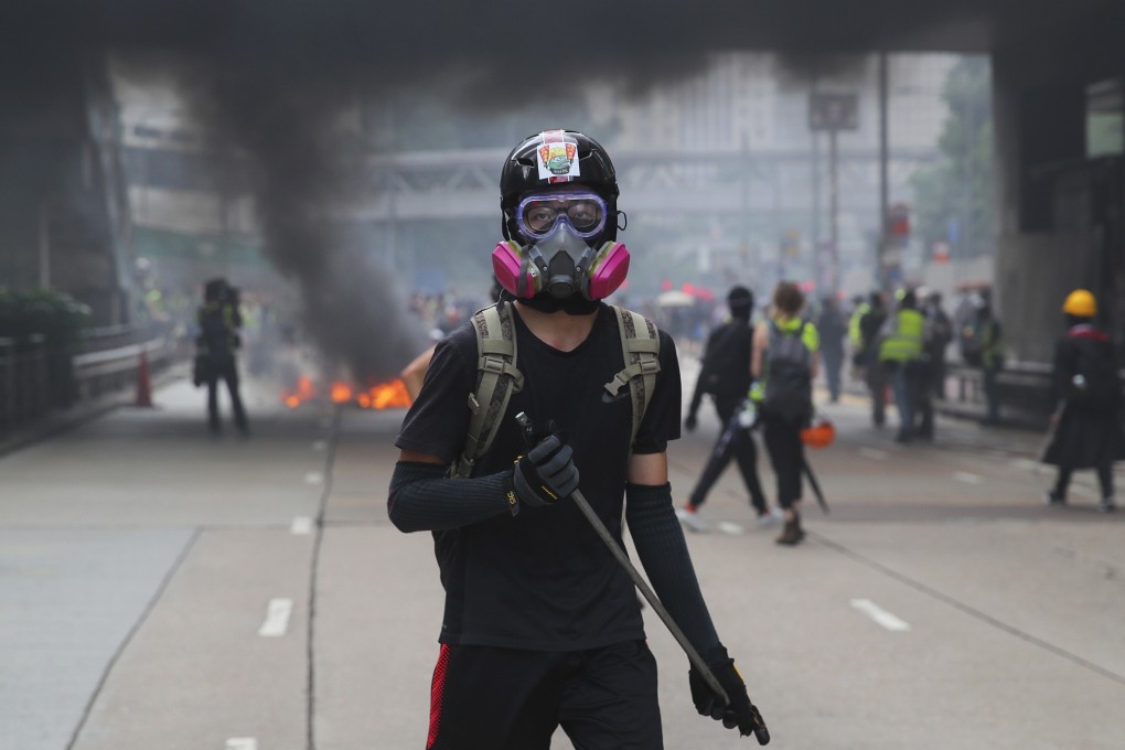 An anti-government protester holds a baton during a rally in Hong Kong last September. Photo: EPA-EFE
