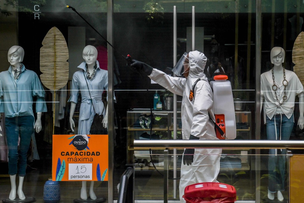 A worker disinfects a shopping mall during the coronavirus pandemic, in Medellin, Colombia. The fashion industry is looking into the many ways it can fight the spread of viruses and bacteria in its clothing. Photo: AFP