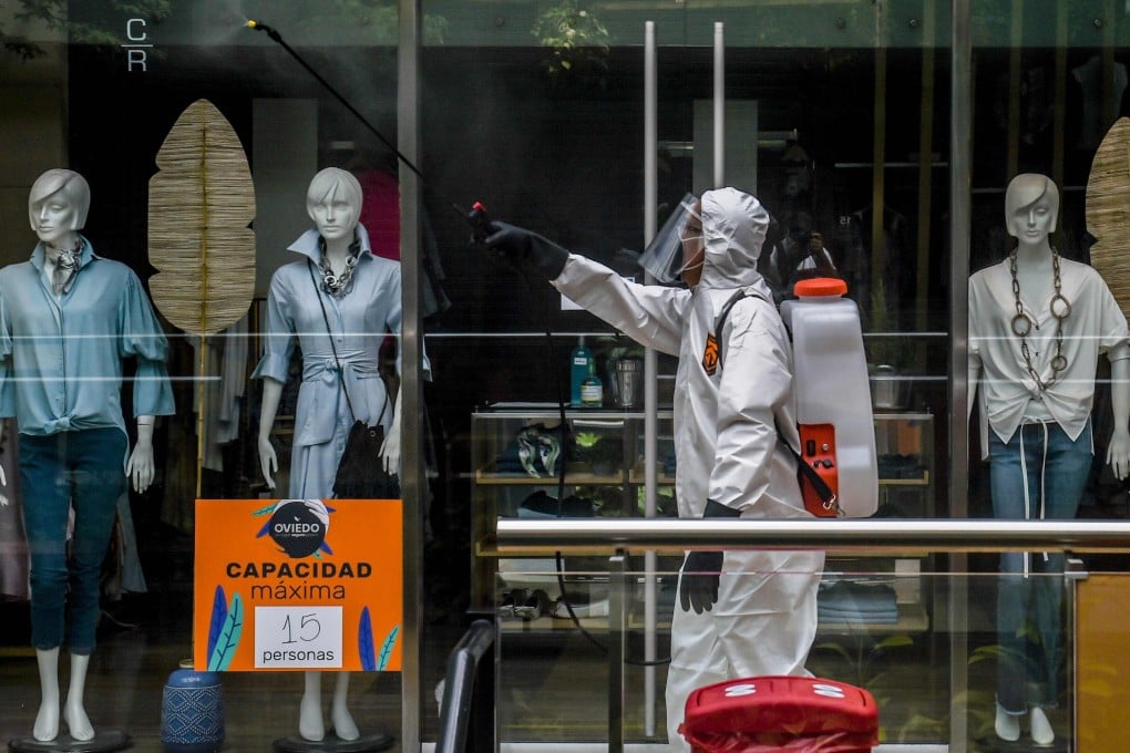 A worker disinfects a shopping mall during the coronavirus pandemic, in Medellin, Colombia. The fashion industry is looking into the many ways it can fight the spread of viruses and bacteria in its clothing. Photo: AFP