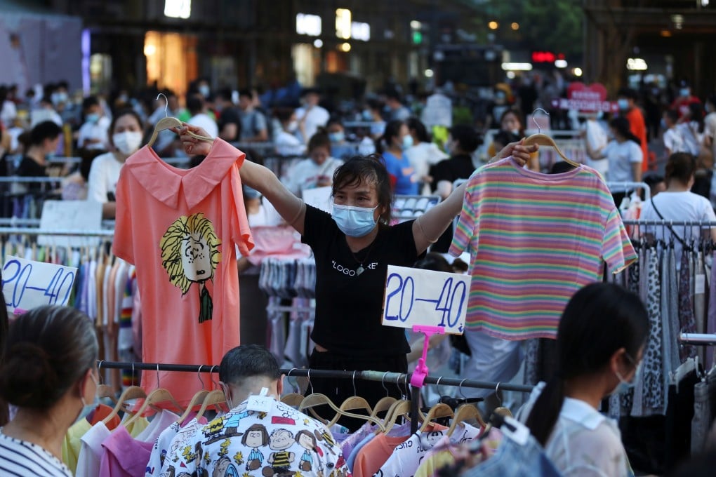 A vendor displays clothing items for sale at a street stall in Wuhan. Photo: Reuters