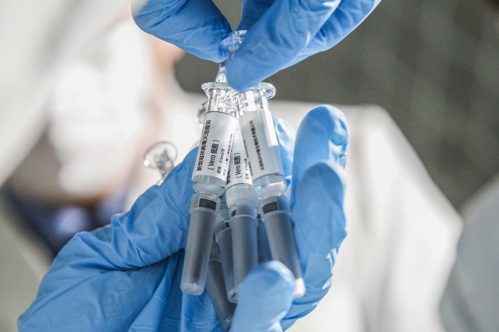 A staff member displays samples of the Covid-19 inactivated vaccine at Sinovac Biotech in Beijing. Photo: Xinhua