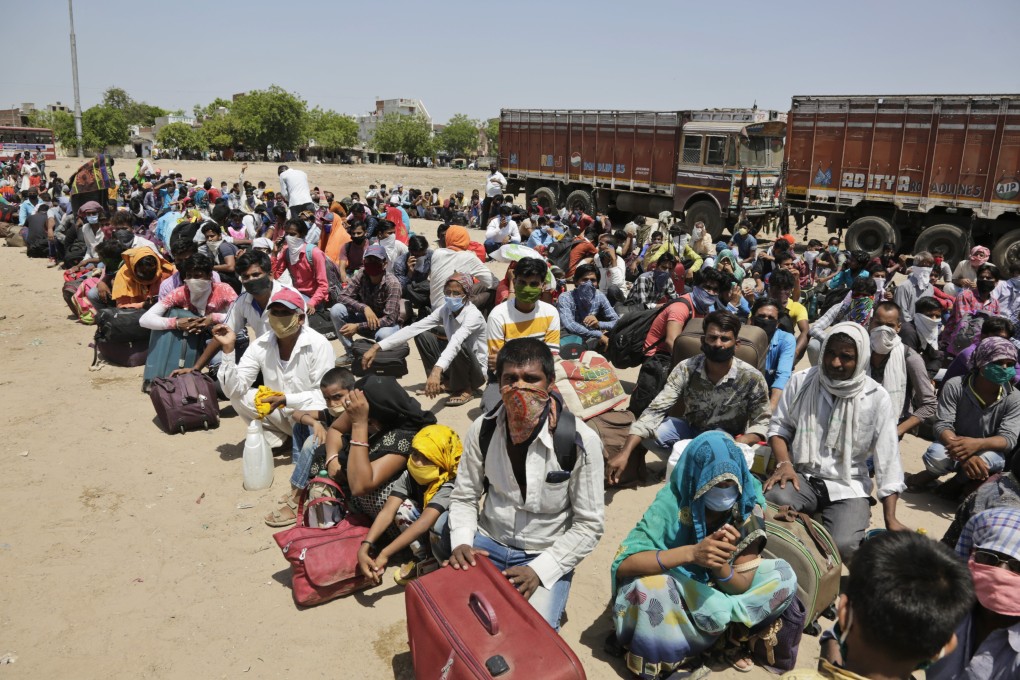 Migrant workers desperate to return to their homes wait for transport to a railway station in Ahmedabad, India, on May 13. Photo: AP